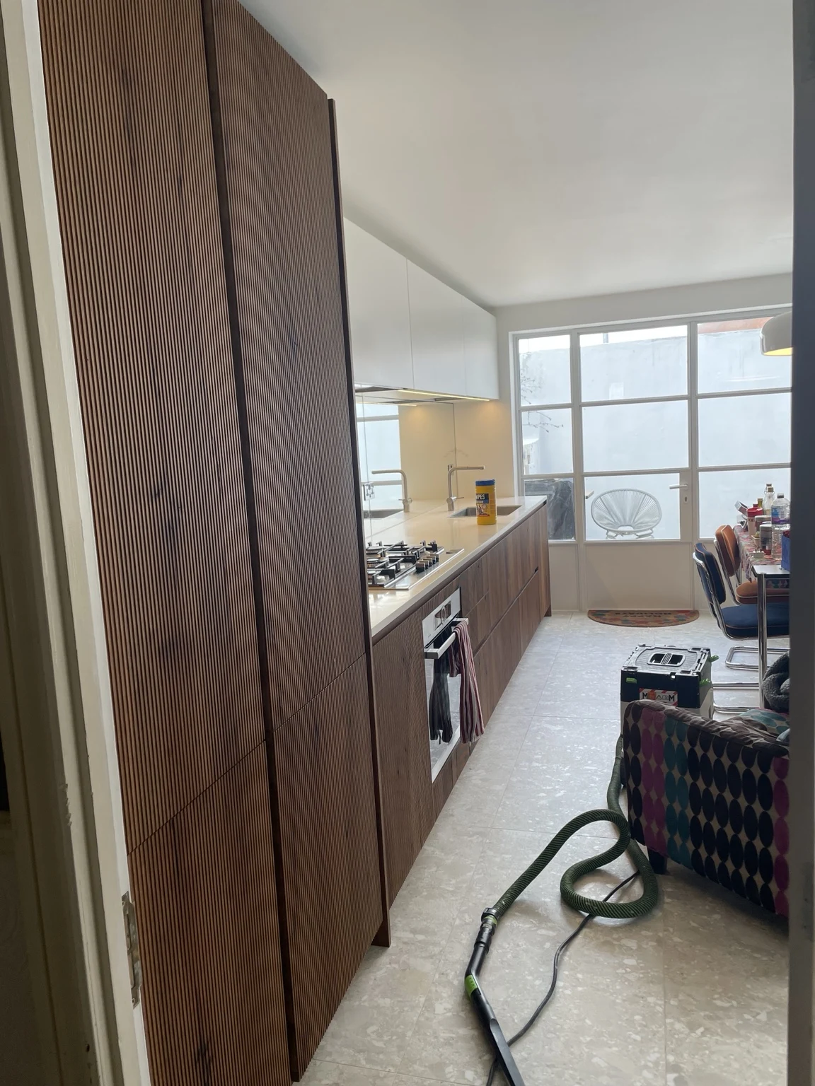 Kitchen with timber cabinetry and pale worktops