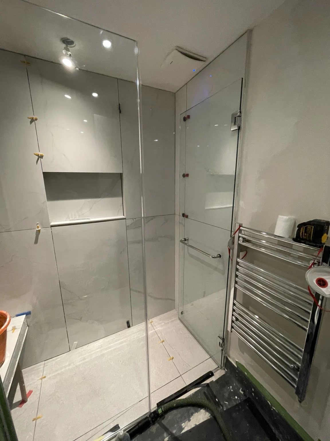 Tiled shower and towel radiator during finishing work