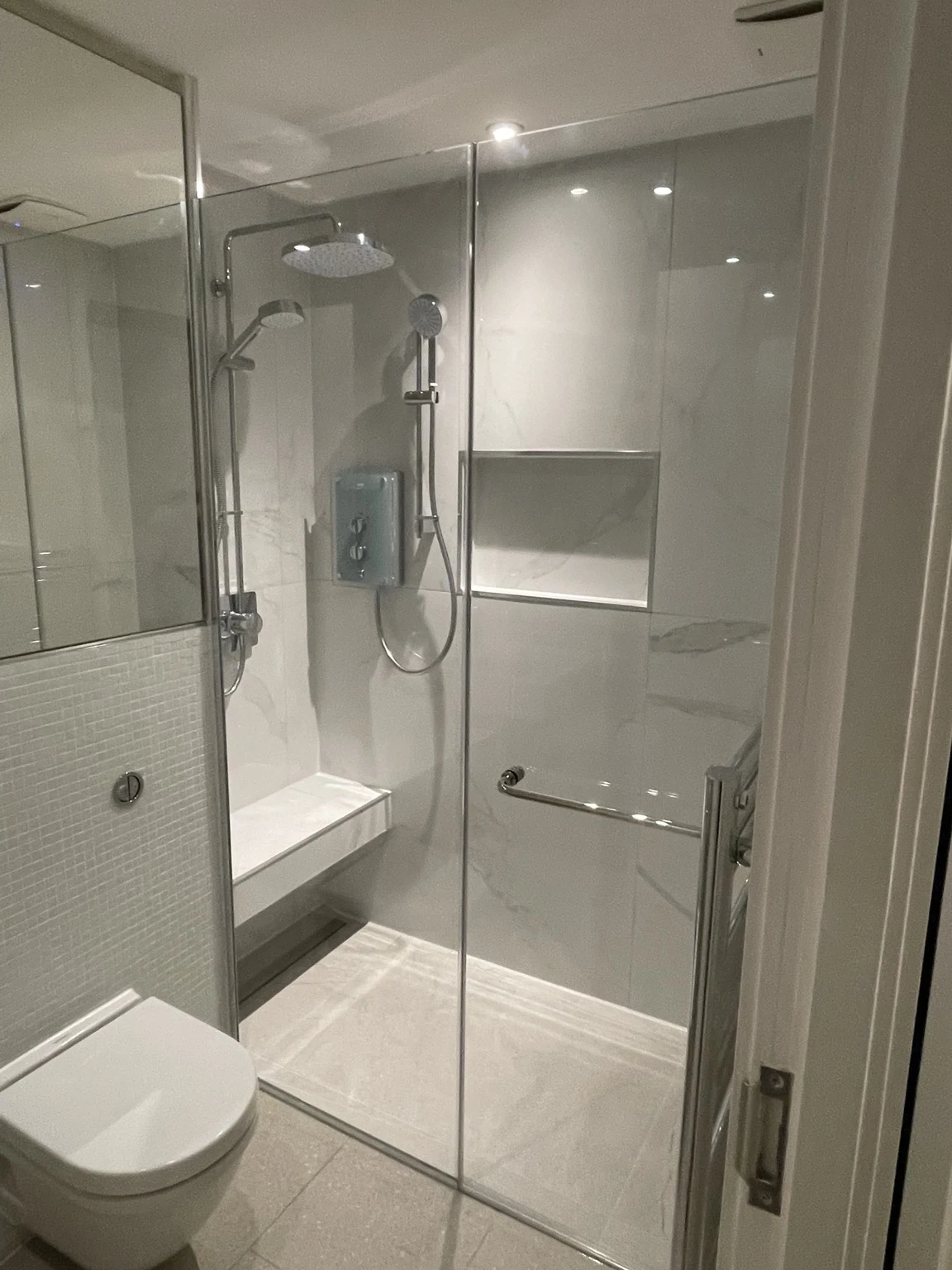 Completed tiled bathroom and glazed shower enclosure