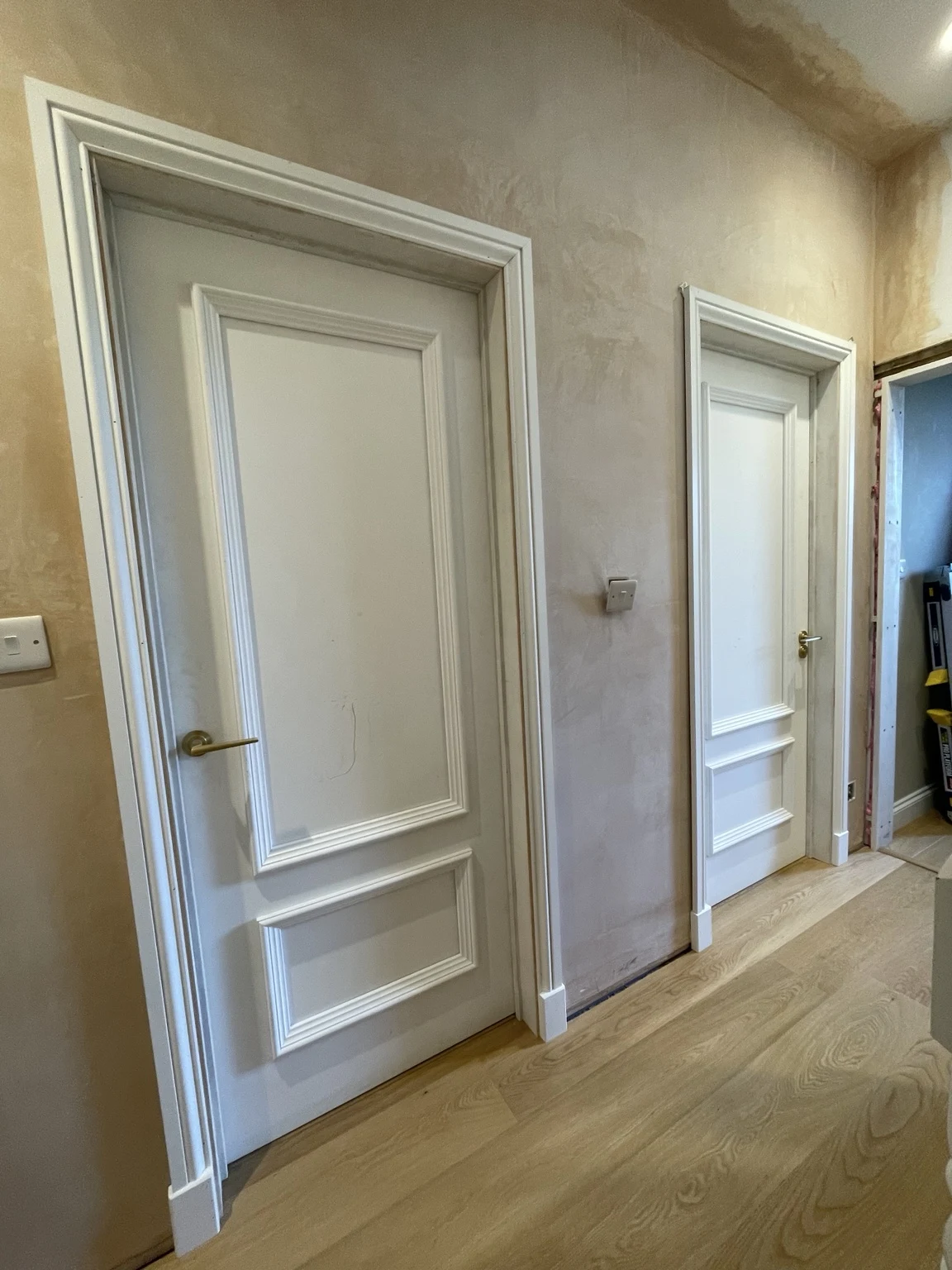 Panelled doors and trim along an interior hallway