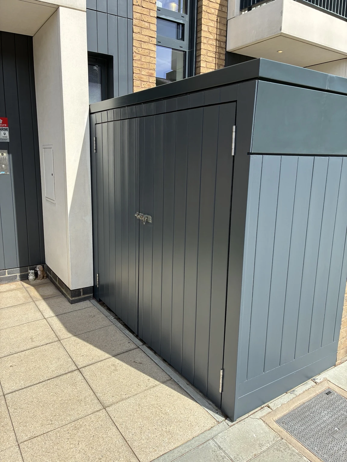 Completed dark panelled outdoor storage enclosure