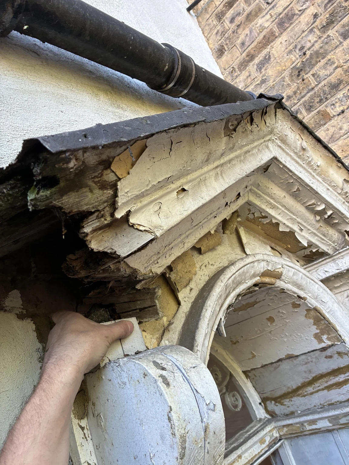 Close-up of damaged decorative entrance timber during restoration